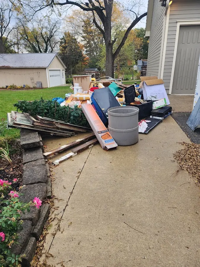 Dumpster being loaded with debris for 12 Yard Dumpster Rental in Middletown